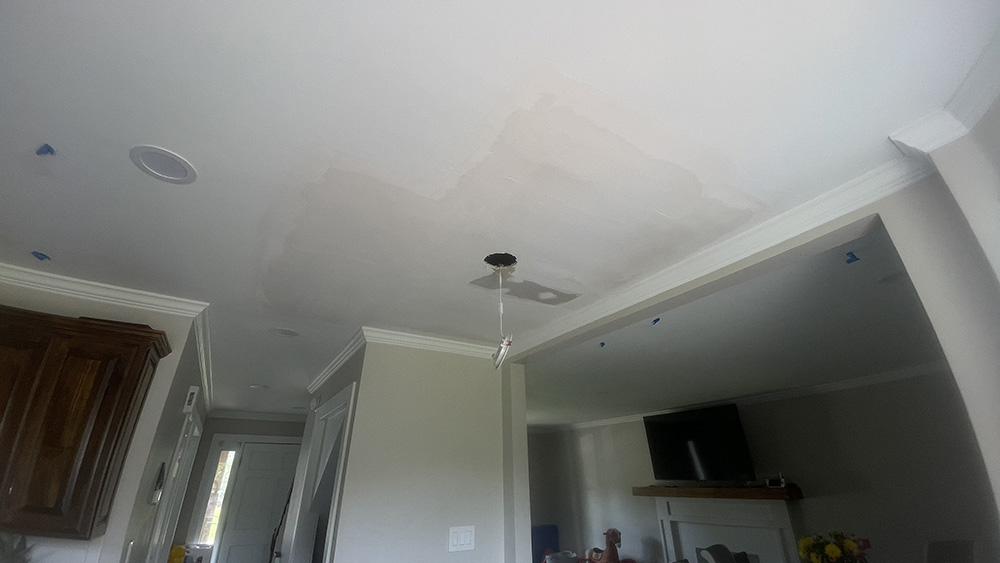 Wide feathered joint compound float surrounding recessed can light